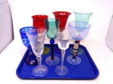 A tray containing eight glass tall stem wine glasses and goblets to include Murano, Athens 2004,