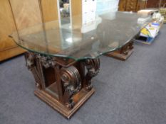 A contemporary glass topped dining table on ornate classical pedestals CONDITION REPORT: