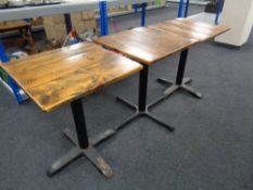 Three square pine topped bistro tables on cast iron bases