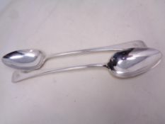A pair of large silver plated serving spoons.