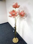 A brass four-way floor lamp with glass petal shades