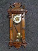 A 19th century mahogany Vienna wall clock with brass and enamel dial