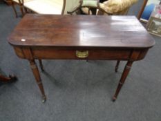 A 19th century mahogany D-shaped table fitted a drawer on tapered legs