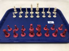 A carved and stained bone chess set, kings 7.