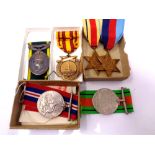 Four WWII war medals on ribbons to include the 1939-45 Star, The Africa Star,