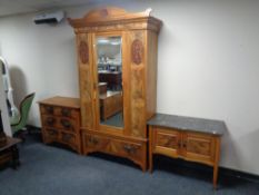 An Edwardian burr walnut three-piece bedroom suite comprising mirrored door wardrobe,