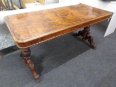 A Victorian mahogany and burr walnut library table on carved legs