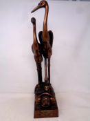 A Japanese style patinated metal figure of two stalks stood atop a turtle