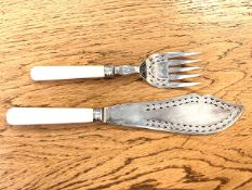 A fish knife and fork with Silver ferrules.