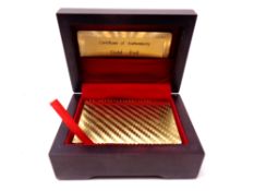 A pack of 24ct gold foil playing cards in a wooden box