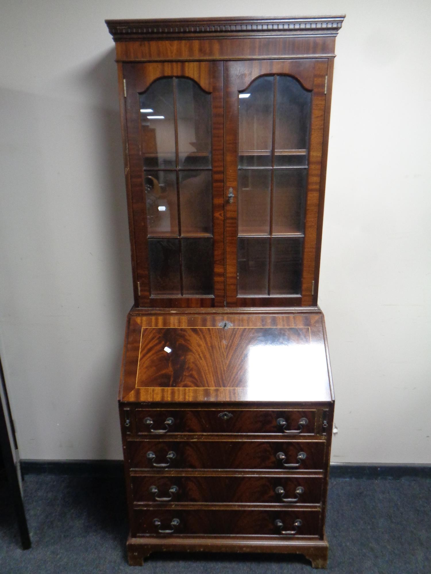 A reproduction inlaid mahogany bureau bookcase