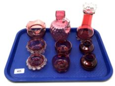 A tray containing nine pieces of antique cranberry glassware to include vase, jug,