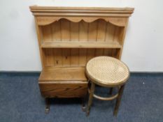 A pine kitchen plate rack together with a small oak drop leaf table and a rattan stool