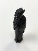 A Japanese carved hardwood netsuke of a figure holding a staff, signed, height 6.