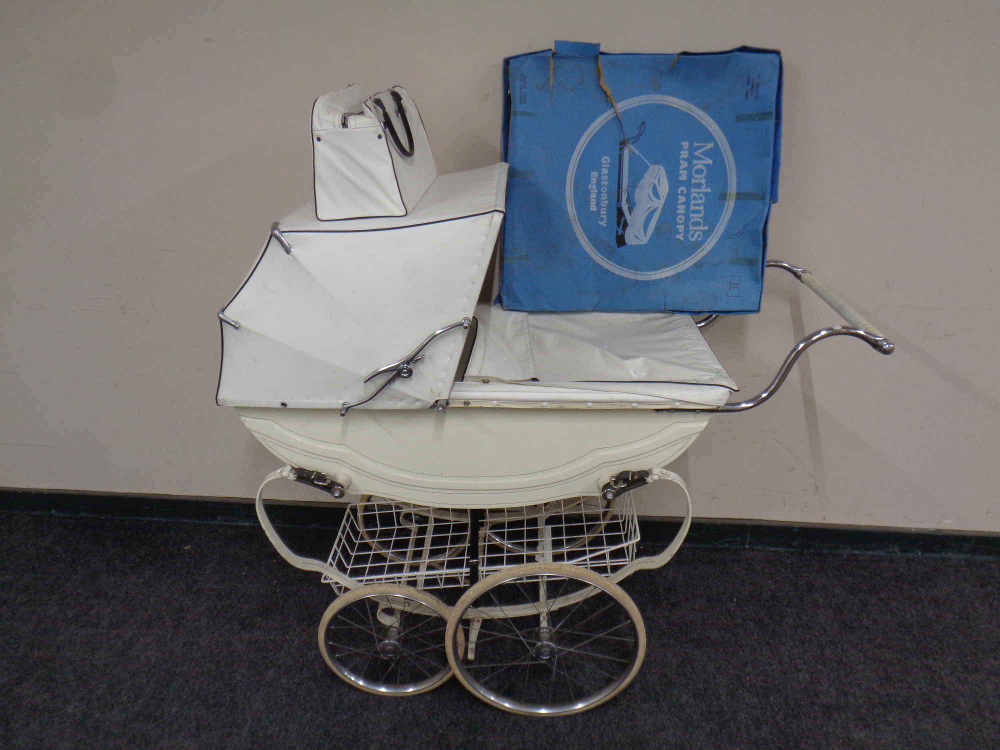 A Fetha-Lite pram together with the matching leather bag