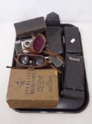 A tray of antique cameras, field glasses, boxed student microscope no.