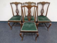 A set of four Edwardian mahogany dining chairs on cabriole legs