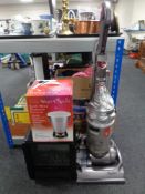 A Dyson DC14 animal upright vacuum together with a Dimplex coal-effect electric heater and a