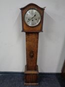 An oak grandmother clock with silvered dial