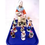 A tray containing large Staffordshire figures of a seated lady together with eight further