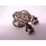 A silver Marcasite brooch together with a pair of earrings.