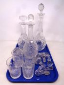 A tray containing three cut glass decanters with stoppers together with a quantity of decanter