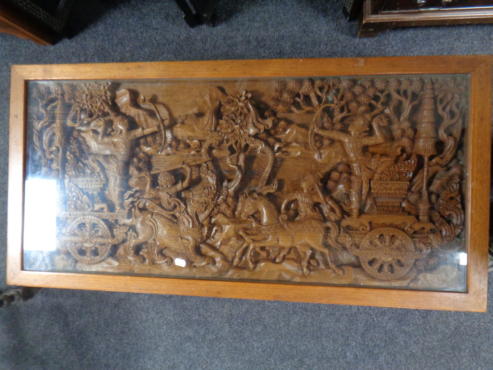 A heavily carved Thai rectangular coffee table with glass top - Image 2 of 2