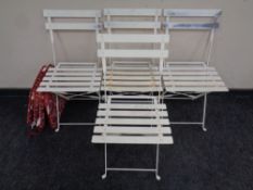 A set of four folding metal patio chairs with cushions (4)