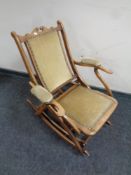 A beech rocking chair in studded dralon upholstery