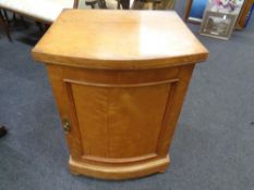 A 19th century satin wood bow fronted pedestal cabinet on bun feet