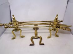 A three-piece 19th century brass companion set with fire dogs