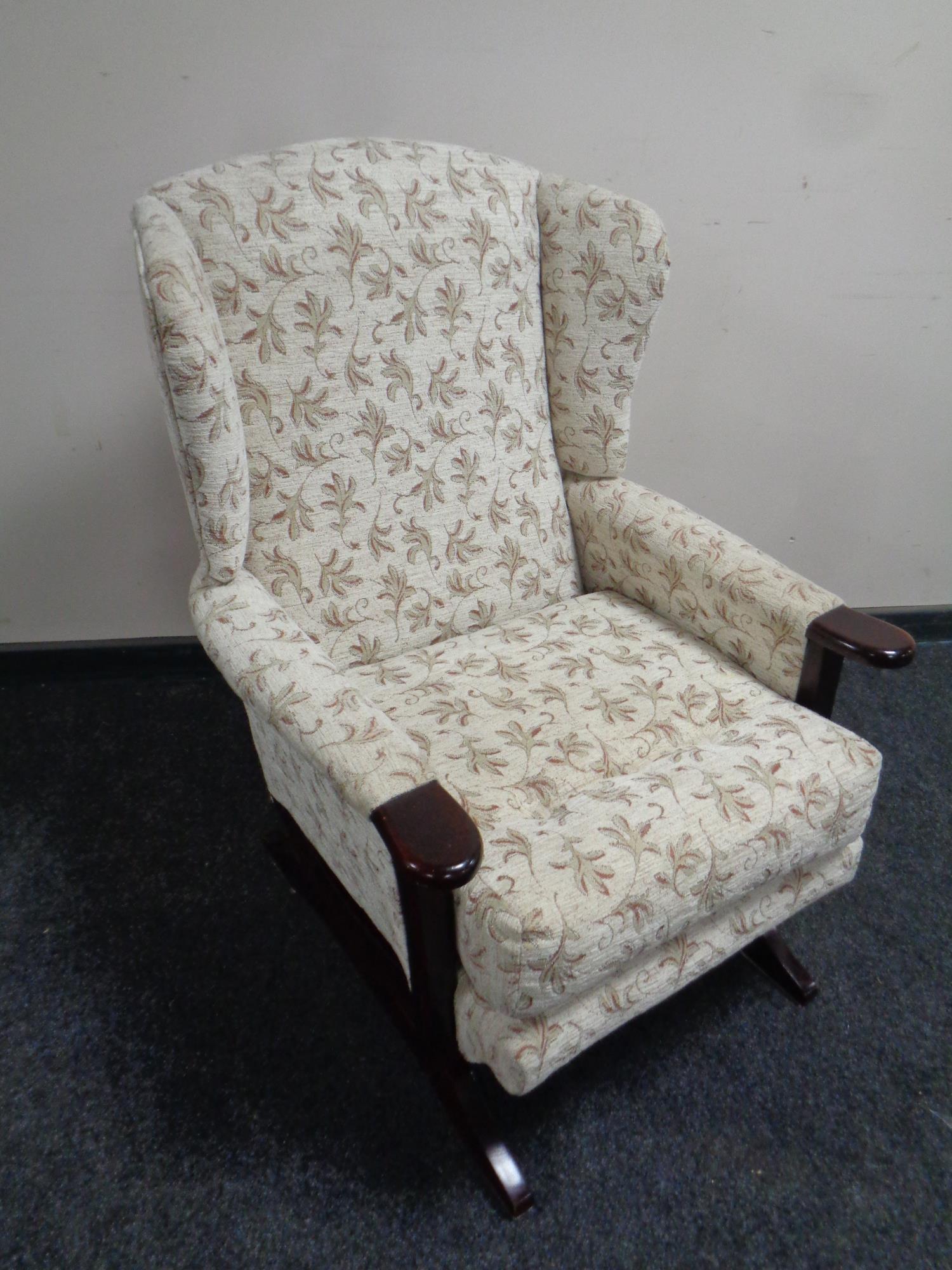 A 20th century beech framed wingback armchair