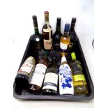 A tub of ten bottles of alcohol to include Courvoisier Cognac, wines, Baileys,