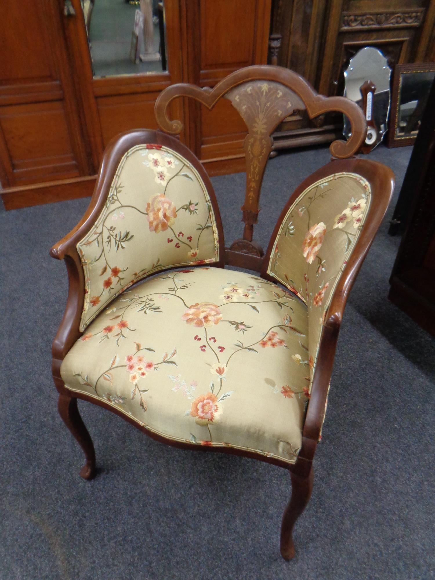 An Edwardian inlaid mahogany Sheraton style armchair upholstered in a floral tapestry fabric