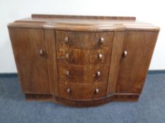 A 1930's bowfront oak sideboard