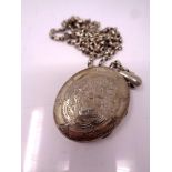 A large vintage silver locket on chain.