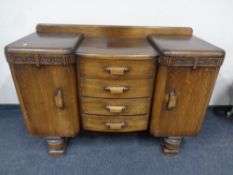 A 1930's inverted break front double door sideboard fitted four central drawers