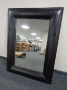 A contemporary leather framed mirror