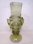 A green-tinted vase with animal head decoration (height 27.