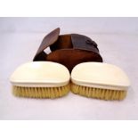 A pair of antique ivory-backed clothes brushes in leather case