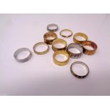 A quantity of brass sample wedding band rings.