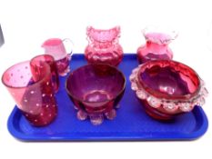 A tray containing seven pieces of antique cranberry glassware to include jug, vases,