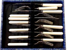 A cased set of Silver plated knives and forks.