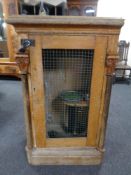A 19th century continental oak single door cabinet converted to a falconry cabinet