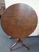 A 19th century circular oak topped pedestal table