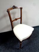 A Victorian burr walnut bedroom chair in cream upholstery