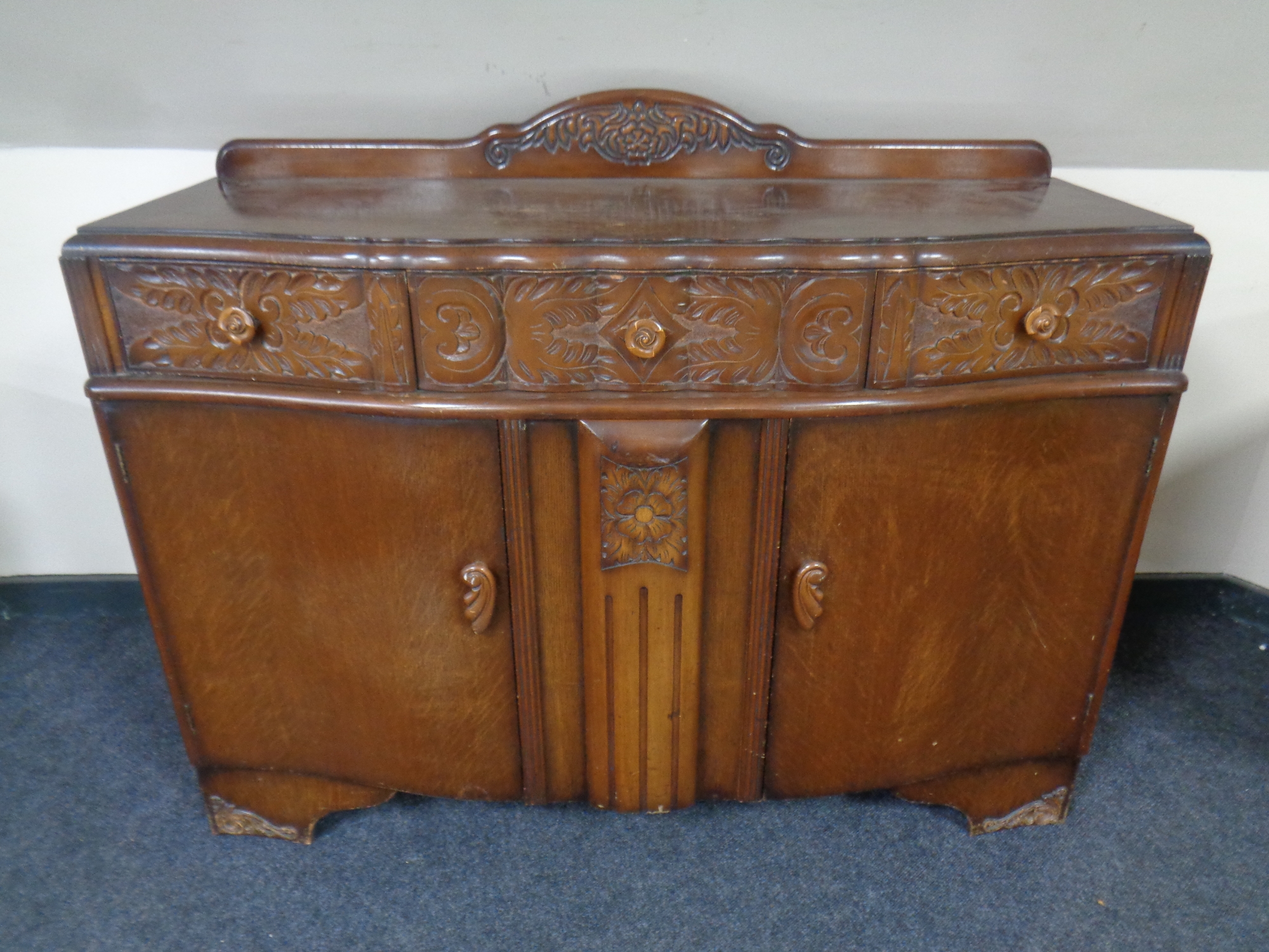 A 1930's carved oak sideboard