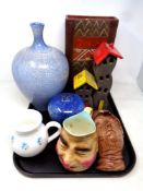 A tray containing assorted ceramics to include character jug, a Greek Rozos pottery house ornament,