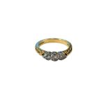 An 18ct yellow gold diamond three stone ring, size J.