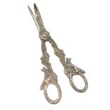 A very ornate pair of silver grape scissors depicting foxes.